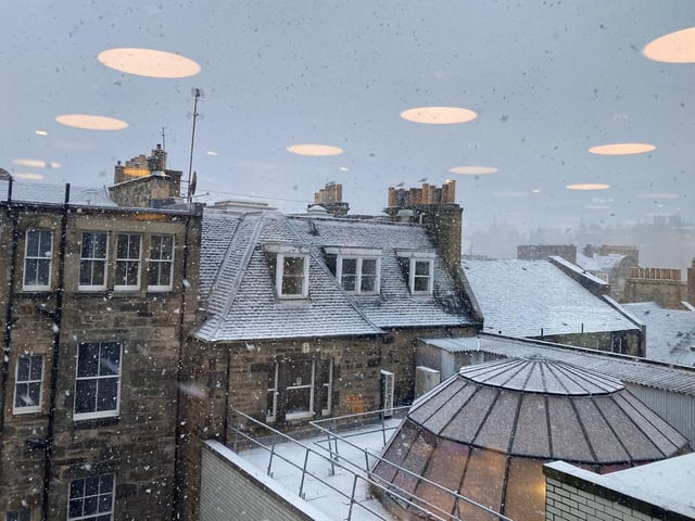 Rooftops looked as though they'd been dusted with icing sugar, as flurries of snowflakes fell on the city.