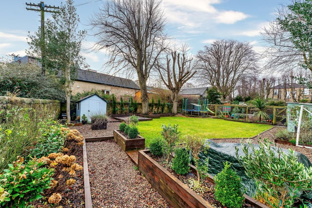 Outside, there is an extensive private walled garden to the rear. It has a desirable south-facing position with mature trees and borders as well as a large lawn, patio, two timber sheds, traditional drying line and a chicken coop. To the front of the property, there is a low maintenance, well-kept area of gated and enclosed garden ground.