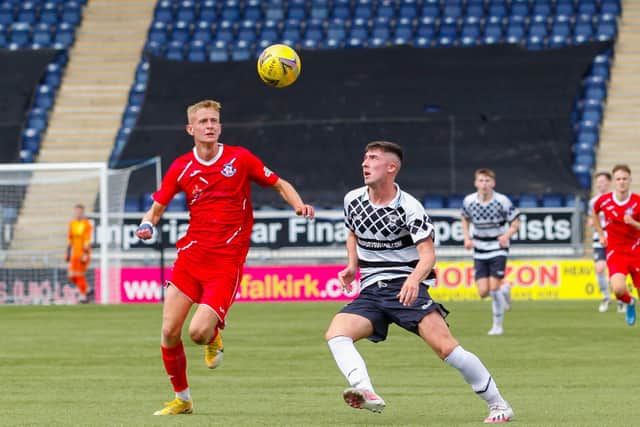Matthew Shaw keeps his eye on the ball for Civil Service Strollers against Dean Watson of East Stirlingshire