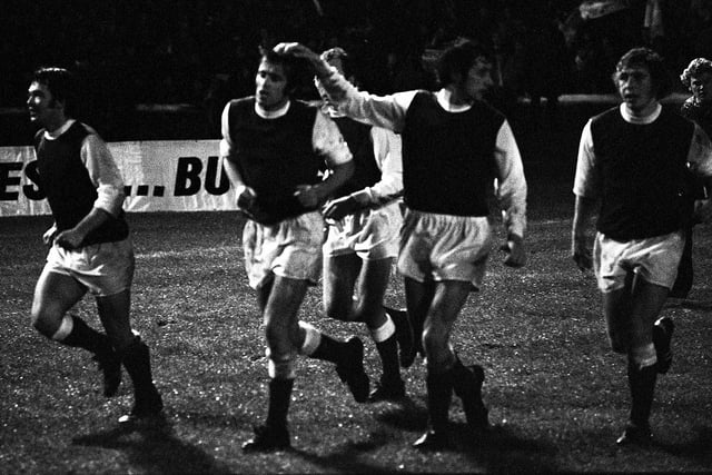 Jimmy O'Rourke, Pat Stanton, Jim Black, and Arthur Duncan, with Alan Gordon partially hidden at the rear, celebrate Hibs' victory