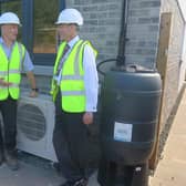 Springfield site manager Darren Brownridge with Councillor Stuart McKenzie by one of the Air Source Heat Pumps.