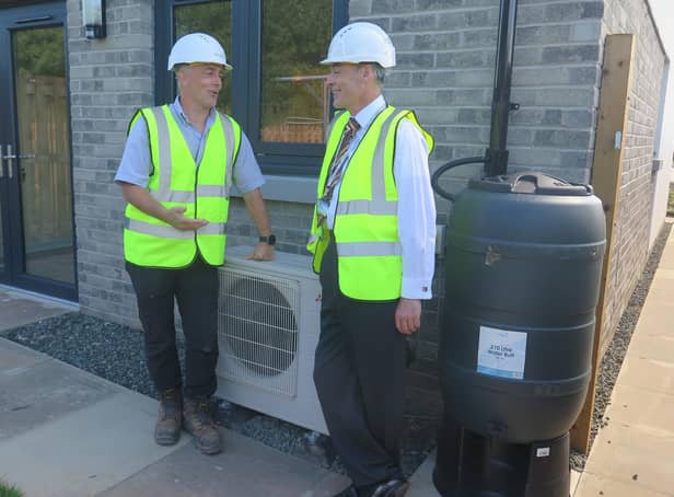 Springfield site manager Darren Brownridge with Councillor Stuart McKenzie by one of the Air Source Heat Pumps.