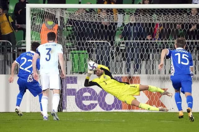 Craig Gordon saves a penalty in Moldova to help Scotland qualify for the World Cup play-offs (AP Photo/Sergei Grits)