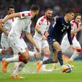 Scotland's Aaron Hickey controls the ball under pressure during the UEFA Euro 2024 Qualifying Group A match at Hampden Park, Glasgow.