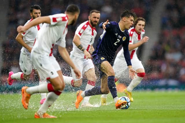 Scotland's Aaron Hickey controls the ball under pressure during the UEFA Euro 2024 Qualifying Group A match at Hampden Park, Glasgow.