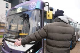 A passenger waits to board a 'driverless' bus