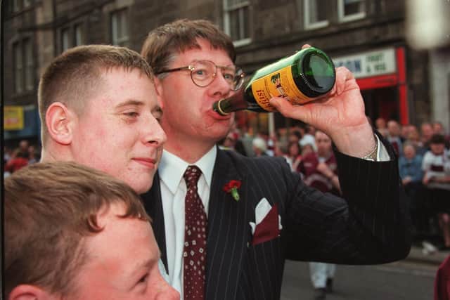 Eric Milligan enjoys a wee sip of Buckfast wine with Hearts fans after their team beat Rangers 2-1 to win the Scottish Cup 1998  Pic Adam Elder