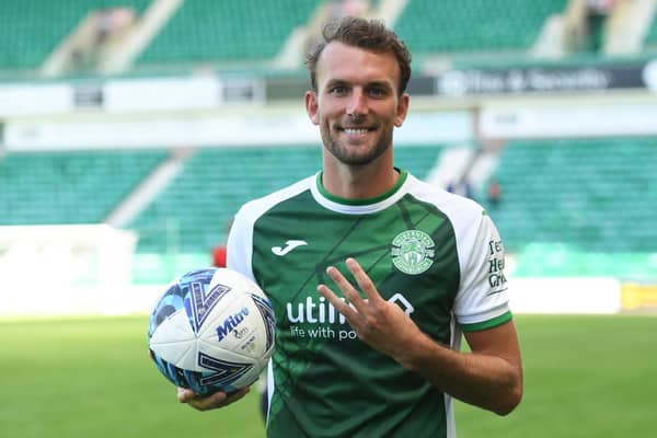 Christian Doidge celebrates with the match ball after netting a hat-trick against Clyde