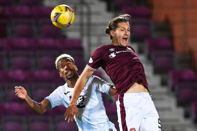 Peter Haring challenges Manny Duku during Hearts' 3-1 win over Raith.
