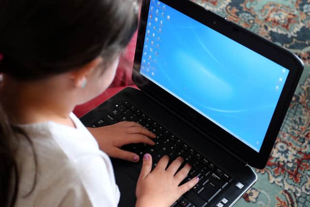A child using a laptop computer, as a "tsunami" of online child abuse is taking place in the UK, the NSPCC has said. Picture: Peter Byrne/PA Wire