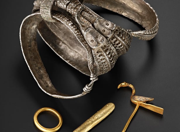 The silver bracelets and gold bird pin found among the collection that was buried in Galloway. PIC: NMS.