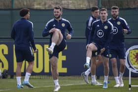 Craig Halkett, Kenny McLean, Grant Hanley and Ross Stewart limber up (front to back) during Scotland training at Oriam