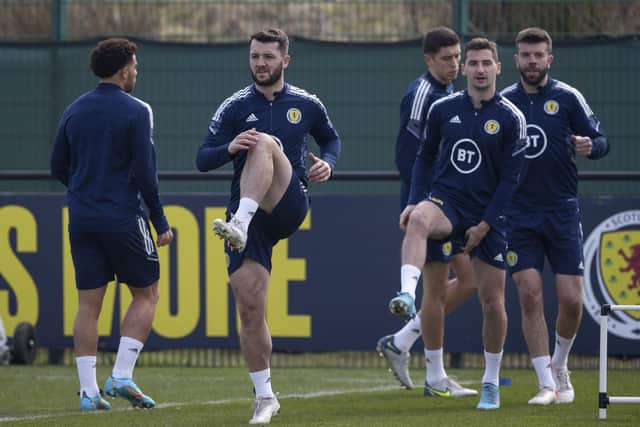 Craig Halkett, Kenny McLean, Grant Hanley and Ross Stewart limber up (front to back) during Scotland training at Oriam