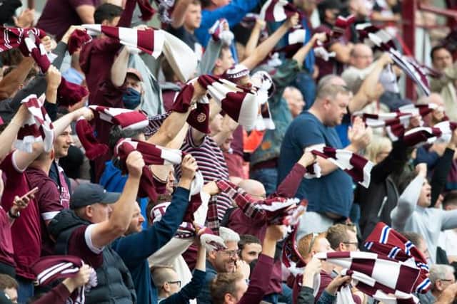 Hearts fans twirl their scarves in the 26th minute in memory of former captain Marius Zaliukas during a cinch Premiership match between Hearts and Aberdeen at Tynecastle Park, on August 22, 2021, in Edinburgh, Scotland. (Photo by Mark Scates / SNS Group)