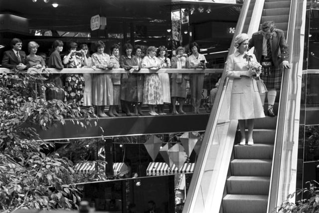 Queen Elizabeth II officially opened the Waverley Market shopping centre in Princes Street Edinburgh, July 1985. The Queen comes down the escalator.