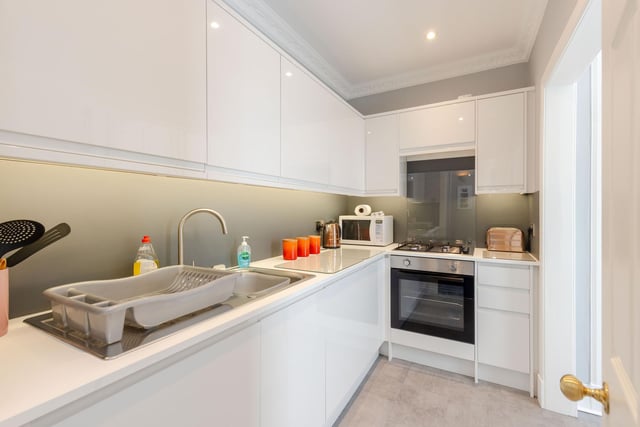 The Kitchen is fitted with a range of sleek gloss base and wall mounted units with co-ordinating worksurfaces and splash backs. There is an integrated oven, hob, fridge and freezer.