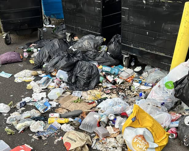 Discarded rubbish next to the communal black bins in Blackburn.