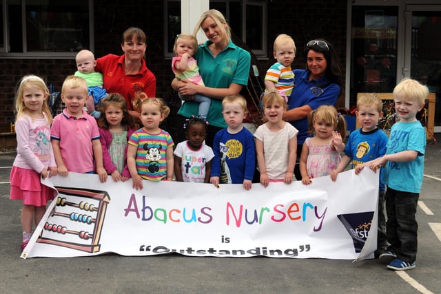 Staff and youngsters from Abacus Day Nursery celebrate their Outstanding Ofsted result in 2013. Is there someone you know in this photo?