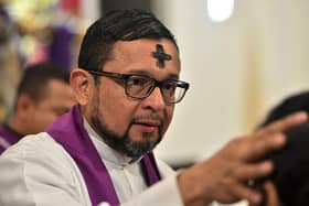 A priest will officiate Ash Wednesday by rubbing ashes in a cross-shape onto the head of church-goers, signifying the beginning of Lent (Picture: Getty Images)