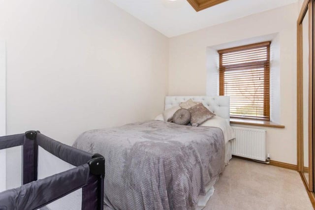 One of the four bedrooms on the upper floor which boasts fitted wardrobes.