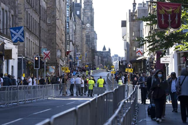 Police and security guards are seen on the Royal Mile as Edinburgh prepares for thousands of well-wishers to line streets of the city