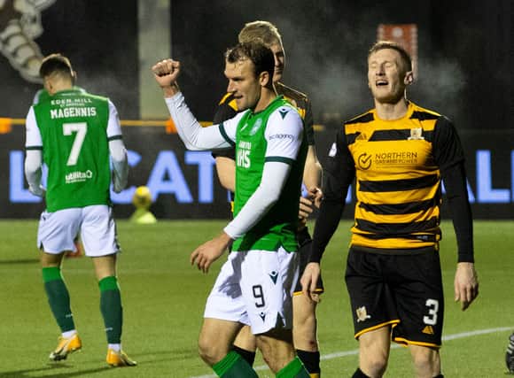 Christian Doidge celebrates after scoring his, and Hibs' second goal