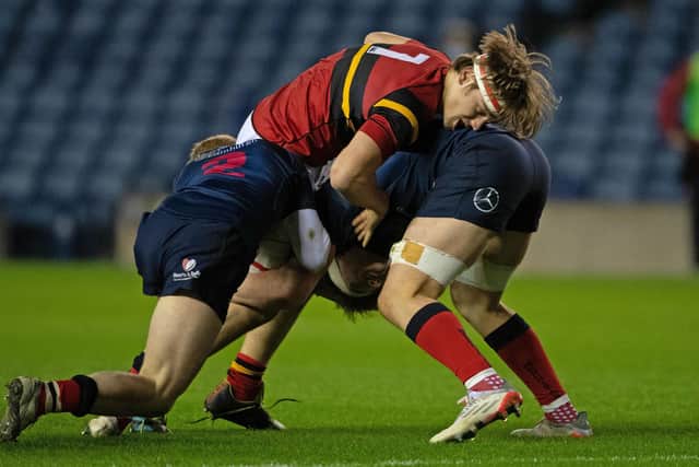 Stewart Melville's Freddy Douglas is tackled during the Scottish schools U-18 cup final at BT Murrayfield
