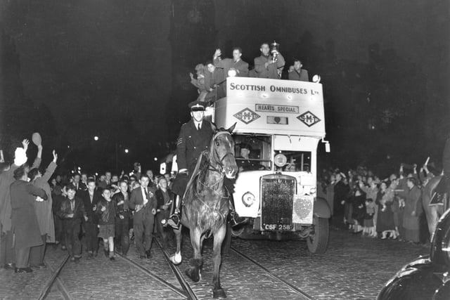 A mounted policeman escorts the Hearts team bus along Princes Street in Edinburgh after they won the Scottish Cup by defeating Celtic at Hampden Park in April 1956.