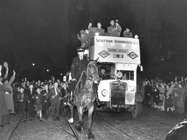 A mounted policeman escorts the Hearts team bus along Princes Street in Edinburgh after they won the Scottish Cup by defeating Celtic at Hampden Park in April 1956.