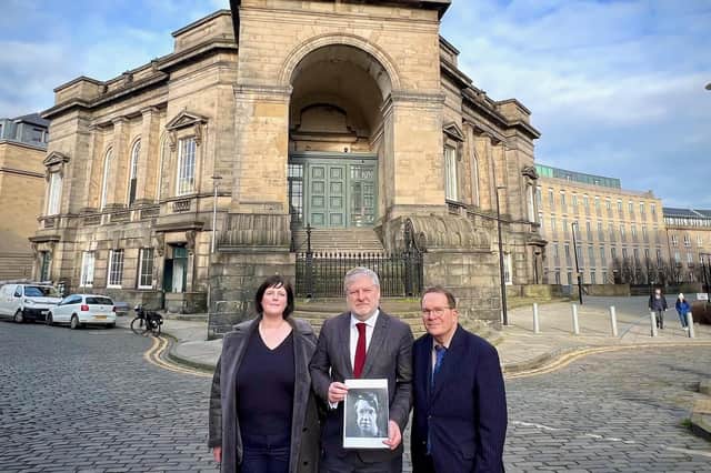 Councillor Vicky Nicolson and Professor Joe Goldblatt with Angus Robertson, who is holding a photograph of Jane Haining