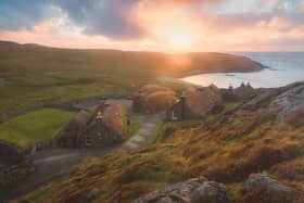 Sunlight over the historic seaside Gearrannan Blackhouse Village on the Isle of Lewis in the Outer Hebrides