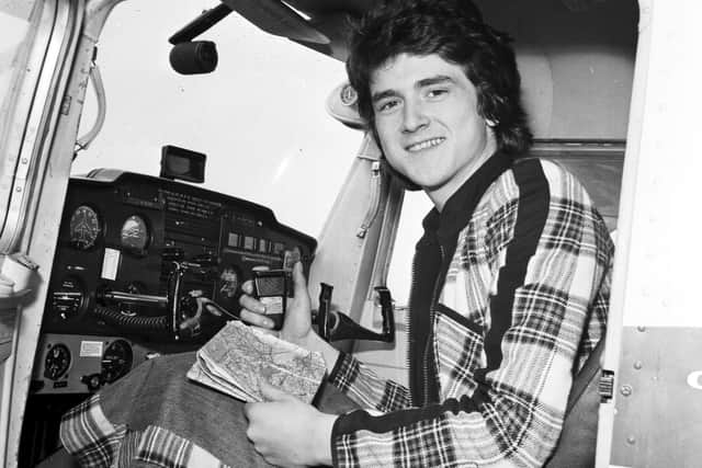 Les McKeown of the Bay City Rollers, dressed in the band's trademark tartan, takes a flying lesson at Turnhouse airport in April 1975