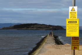 Warnings about the risk of being cut off by the tide are hard to miss on the causeway to Cramond Island (Picture: Ian Rutherford)