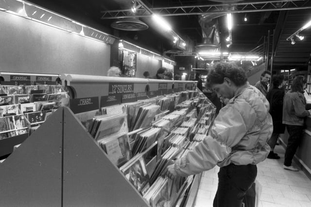 The Other Record Shop moved from the High Street to Princes Street in Edinburgh in December 1985. A man browses the 12" singles.