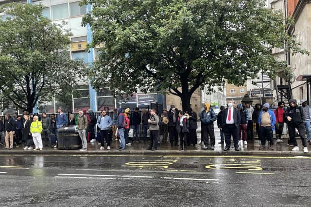 People waiting at a bus stop in Paddington as RMT members on London Underground went on strike
