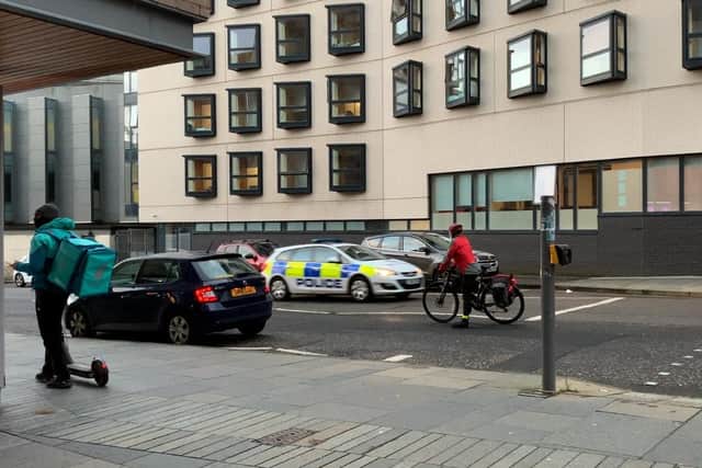 The cyclist refused to pass the black car on the zig-zagged lines as it could also lead to a fine.