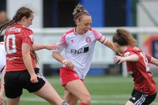 Alana Marshall runs past two Aberdeen players in preseason. Credit: Spartans Women