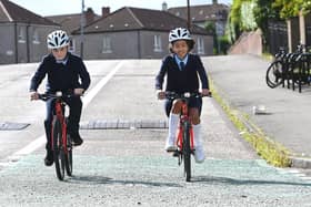 Lochlan Griffiths, ten, and Gabriella Oude, nine, from St Pholomena's Primary  School, demonstrating the new bikes today. Picture: John Devlin