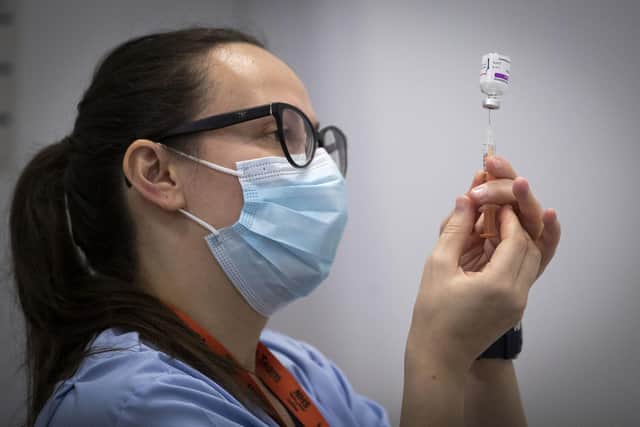 A member of the vaccine team prepares a syringe with a dose of the AstraZeneca/Oxford Covid-19 vaccine at an NHS Scotland vaccination centre set up at the Edinburgh International Conference Centre. (Picture: Jane Barlow/pool/AFP via Getty Images)