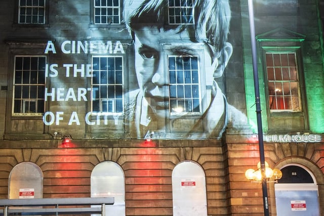 An image from the classic Bill Douglas film My Childhood, projected onto the Filmhouse in Edinburgh, is one of several movie images projected onto landmarks and public buildings in the city as part of the campaign to save the Edinburgh International Film Festival and the Filmhouse.