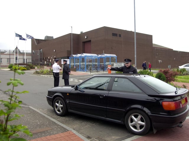 Prison officer guards direct traffic outside Saughton Prison during a hostage situation there in June, 2001.
