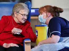 Resident Annie Innes, 90, talks with a healthcare worker at the Abercorn House Care Home in Hamilton.