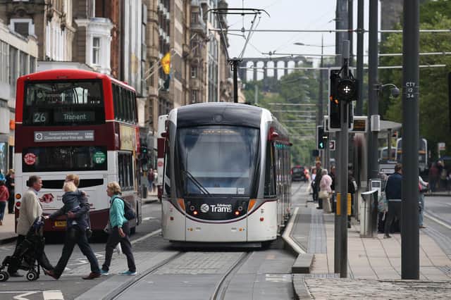 A tram and a bus pass by each other on Edinburgh's Princes Street (Picture: Andrew Milligan/PA)