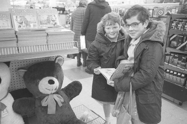 Two young shoppers look at books in one of the town centre shops in 1980, but which shop is it?