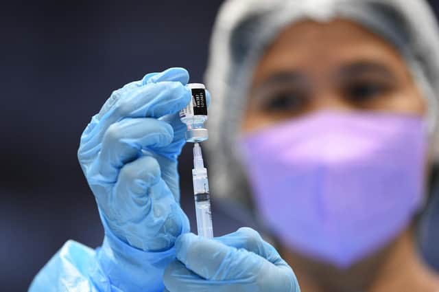 A medical worker prepares a BioNtech-Pfizer Covid-19 coronavirus vaccine at a colisium in Makati City, suburban Manila on November 29, 2021, as the Southeast Asian nation launched a three-day vaccination drive targeting nine million people as young as 12 in an effort to accelerate the roll-out of jabs, amidst the threat of heavily mutated coronavirus variant Omicron. (Photo by Ted ALJIBE / AFP) (Photo by TED ALJIBE/AFP via Getty Images)