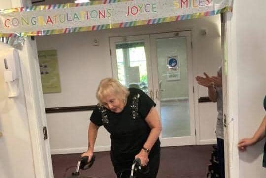 Joyce Douglas completes her five mile walking challenge at Drummond Grange care home in Lasswade.