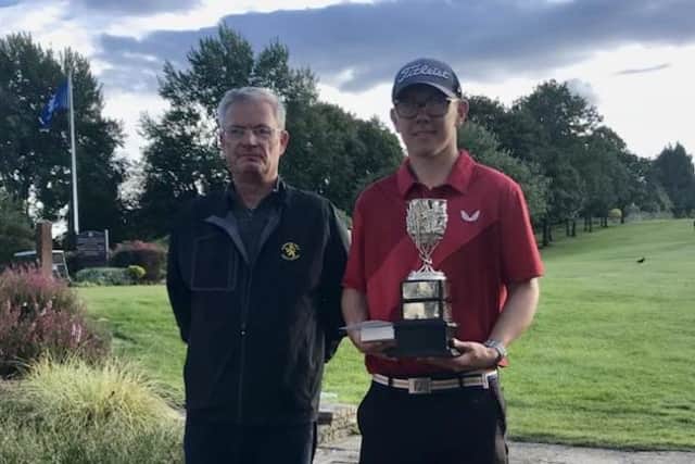Bathgate's James Wood after receving the Lothians Junior Championship trophy from LGA president Neil Anderson after his win in the final at Murrayfield. Picture: LGA