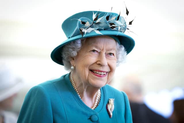 Dressed in a jade green Angela Kelly outfit with a ruby and diamond brooch, the Queen arrived at the University of Edinburgh premises in a hybrid Land Rover, and immediately remarked "it's electric" as she exited the vehicle (Photo by Jane Barlow - WPA Pool/Getty Images).