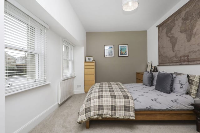Double bedroom two with twin front facing window and built-in wardrobes.