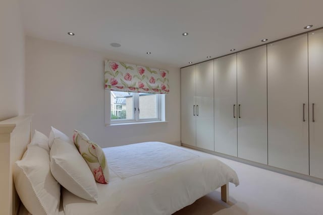 This is the second bedroom, with a range of fitted furniture to one wall.